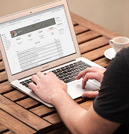 Image of person in custom printed business tee shirt using a computer